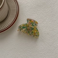 Macro shot of French acetate claw clip featuring colorful marble floral texture - Ghost Hand Claw / Floral Yellow Green