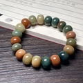 Macro view of colorful drum-shaped Bodhi seed prayer beads on a vintage calligraphy book - Dunhuang Abacus Beads