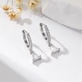 Fashion silver hoop earrings with clear triangle zircon pendant on minimalist white background - Triangle