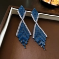 Macro detail of geometric crossed fringe earrings with dark blue and white cubic zirconia - Blue Rhinestone Fringe Drop Earrings (925 Silver Pin)