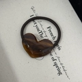 Close-up of brown acetate heart hair tie with France Handmade text and amber texture - Amber