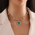 Close-up of golden heart necklace with green gemstone and diamond detailing on neck - Green Heart Gem Style (3#)