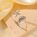 Silver marine theme open bangle featuring detailed starfish and seashell textures - Silver Ocean Starfish