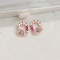 Detailed macro of rose gold heart stud earrings with zircons and pearls on beige velvet - 9# 25069A Rose Gold Hollow Heart
