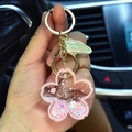 Pink sakura shaped acrylic liquid keychain with floating glitter and golden hook - Pink