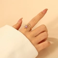 Detail shot of gold sun-shaped ring with purple stones and round white zircon inlay - Sun Purple Style / Purple