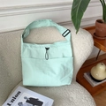Mint green casual canvas crossbody bag on a white sofa in a cozy interior setting - Fresh Green
