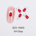 Macro view of 6x10mm red rhinestone butterfly nail charms with silver metal frame - Silver Bowknot Water Drop Red Crystal Style (8909)