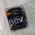 Detail of 7 black spiral hair ties neatly stored in a clear box with holographic BOW logo - Black