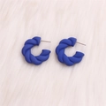Exaggerated twisted C-shaped earrings in matte deep blue resin on white fur background - Royal Blue Twisted