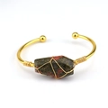 Detailed wire-wrapped unakite crystal stone on a golden open bangle bracelet - Unakite
