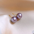 Close-up of elegant purple pearl earrings on a beige silk fabric background - 12mm Round Pearl Stud / Purple