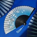 Blue gradient folding fan with white cherry blossoms and blue tassel on bamboo frame - Blue Gradient Butterfly