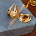 Close-up of chunky gold C-shaped hoop earrings on grey velvet jewelry box - Thickened C-Shape Geometric Style / Gold