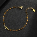 Detail of gold stainless steel cross bracelet with orange beads and lobster clasp - Gold-Orange