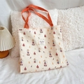 Detail of circus pattern cotton tote bag with orange handles and seersucker texture - Music Box Rabbit