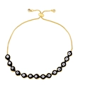 Detail showing 12 black and white evil eye beads on adjustable gold chain bracelet - Black