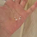 Minimalist silver butterfly stud earrings shown on hand to display mini scale - Mini Butterfly Style (A154)