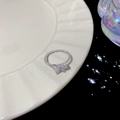 Adjustable silver bow ring with sparkling zircons and a twisted rope band design - J777 Twist Bow Open Ring