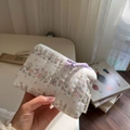 Close-up of quilted floral rabbit pouch held by hand showing soft cotton texture and tag - Striped Rabbit Floral
