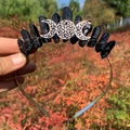 Detail of gothic black crystal headpiece with silver moon symbol and wire wrapping - Black Crystal with Triple Moon