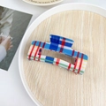 Square hair claw clip featuring vibrant multi-colored plaid patterns in a lifestyle setting - 10cm / Blue Red Stripes