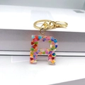 Detail shot of the resin letter R keychain filled with colorful heart-shaped sequins - Letter R Lobster Clasp Keychain