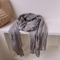 Detail shot of a grey vintage pleated silk scarf draped on a white minimalist shelf - 180*90CM / Cold Gray