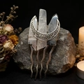 Detail of handmade moon crystal hair fork with silver wire wrapping on rustic stone - Black Rutilated Quartz