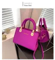 Detail of rose red lychee leather handbag with unique woven knot handle and gold hardware - Rose Red