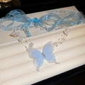 Dettaglio ravvicinato della collana a farfalla in pizzo blu con perle e cristalli lucidi - Collana Di Nastro / Farfalla Blu