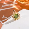 Detailed macro shot of 14K gold plated flower pendant with green zircon gemstone - Flower - Olive Green