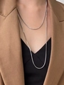 Nahaufnahme der zweilagigen silbernen Schlangenkette auf einem stilvollen Business-Outfit - 120cm / Silber