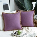 Close-up of purple linen throw pillow covers with decorative braided rope piping on sofa - Violet