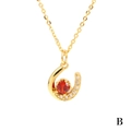 U-shaped gold necklace featuring a red oval zircon and sparkling white crystals - Red Zirconia