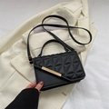 Chic black quilted crossbody bag with golden clasp hardware and adjustable shoulder strap - Black