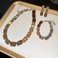 Macro shot of silver jewelry set with amber and clear rectangular crystals on a display - Amber & White Style (3-Piece Set)