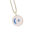Macro view of golden pendant featuring blue evil eye and moon motif with zircon crystals - Blue