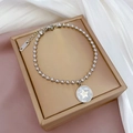 Dettaglio del bracciale a sfere in acciaio inossidabile argento con ciondolo a stella - Stile Conchiglia Bianca Argentata (K312)
