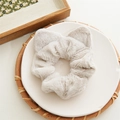 Beige plush scrunchie with cute cat ears design on a ceramic plate - Light Gray
