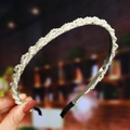 Detail showing hand-woven white pearls on a slim silver metal headband with black end pads - S271-6 Winding Craft Pearl Woven