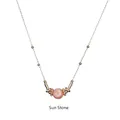 Close-up of a peach sunstone pendant necklace with golden metal beads and fine chain - Sun Stone-Gold Chain