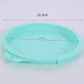 Detail view of 16.3cm mint green silicone cake mold with dimension markings and hanging hole - 6 Inch Round / Mint Green