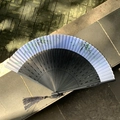 Classical folding fan with ink bamboo pattern and elegant grey tassel on stone - Hollow Bamboo Node Blue Bamboo