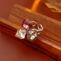 Macro detail of silver chain ring featuring pink, champagne, and smoky square zircons - Three-Stone Open Ring / Silver Ring-Pink/Grey/Champagne Stones
