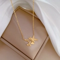 Macro detail of gold plane necklace with Plane engraving on polished titanium steel - Titanium Steel / Gold