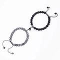 Detail of magnetic heart clasp connecting grey marble and matte black beaded bracelets - Picasso Stone + Matte Stone