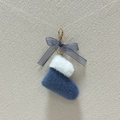 Detail of blue plush Christmas boot keychain with bow and gold metal clasp accessory - Blue
