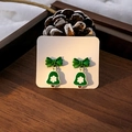 Detail of festive green bow earrings with bell pendants and white snowflake patterns - E5947-12 Bow Snowflake Bell