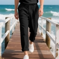 Men's loose black cotton linen trousers with drawstring waist on beach boardwalk - S / Bottoms / Black